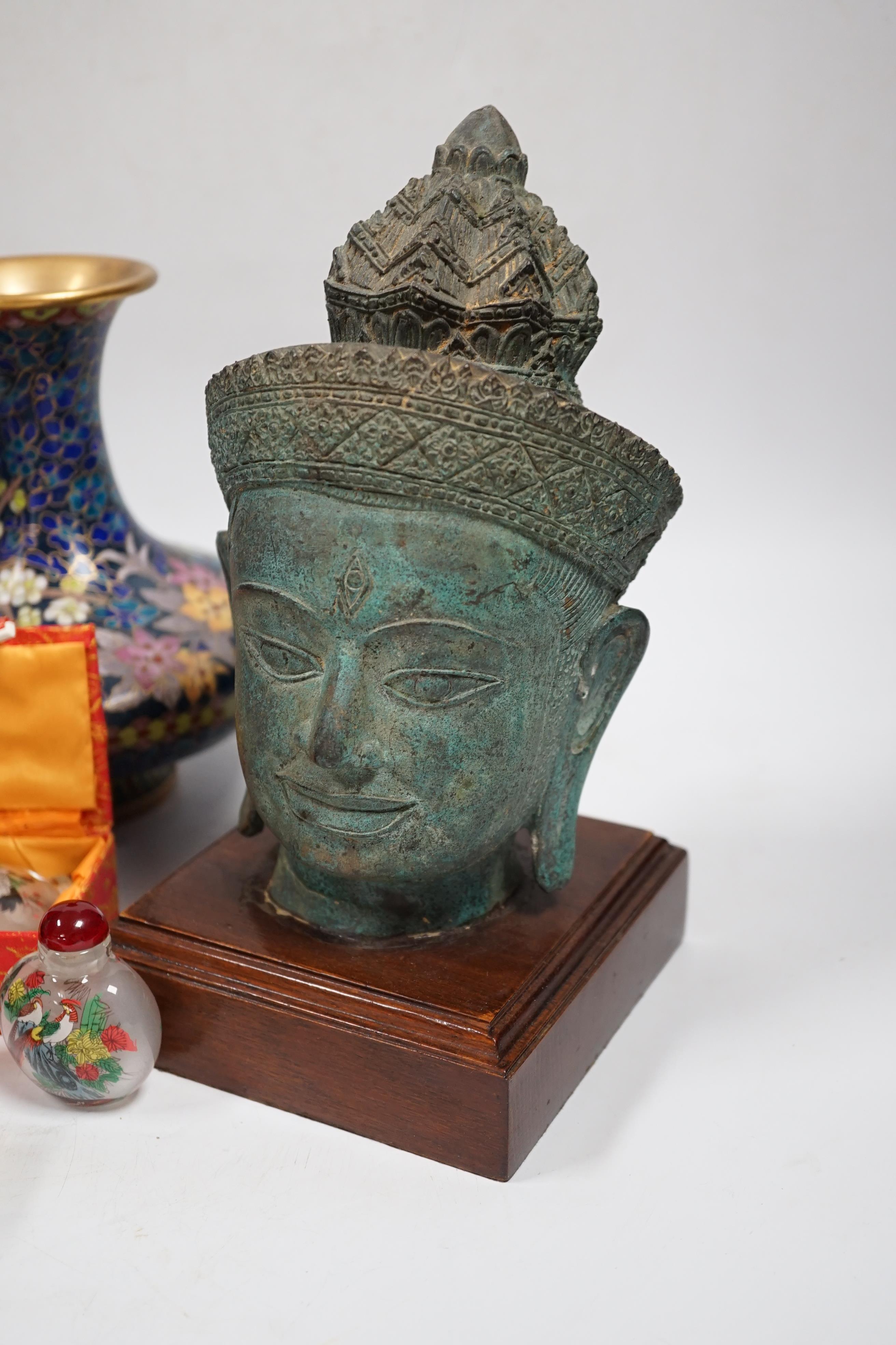 A Thai bronze model of a Buddha head, a pair of Chinese cloisonné vases, reverse painted snuff bottles etc